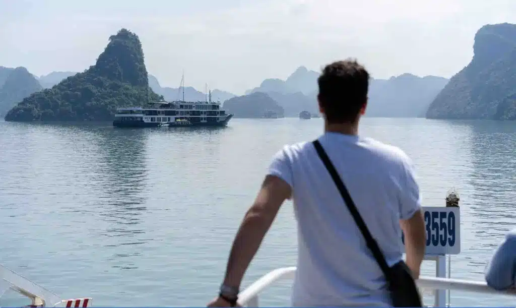 young-man-setting-boundaries-from-working-from-home-going-on-vacation-waiting-for-the-boat-at-the-lake