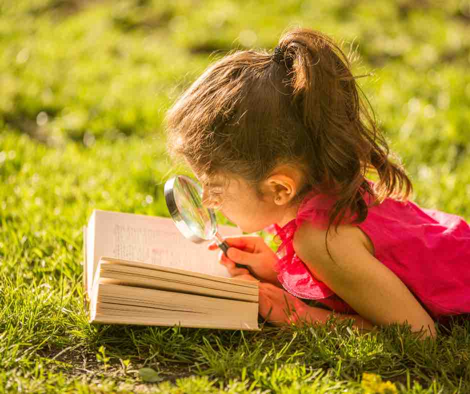 kid-laying-in-the-grass-reading-a-compelling-blog-or-article